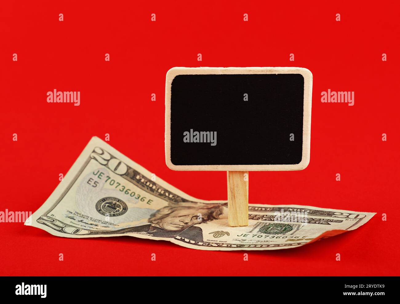 US dollar banknote and blackboard sign on red Stock Photo