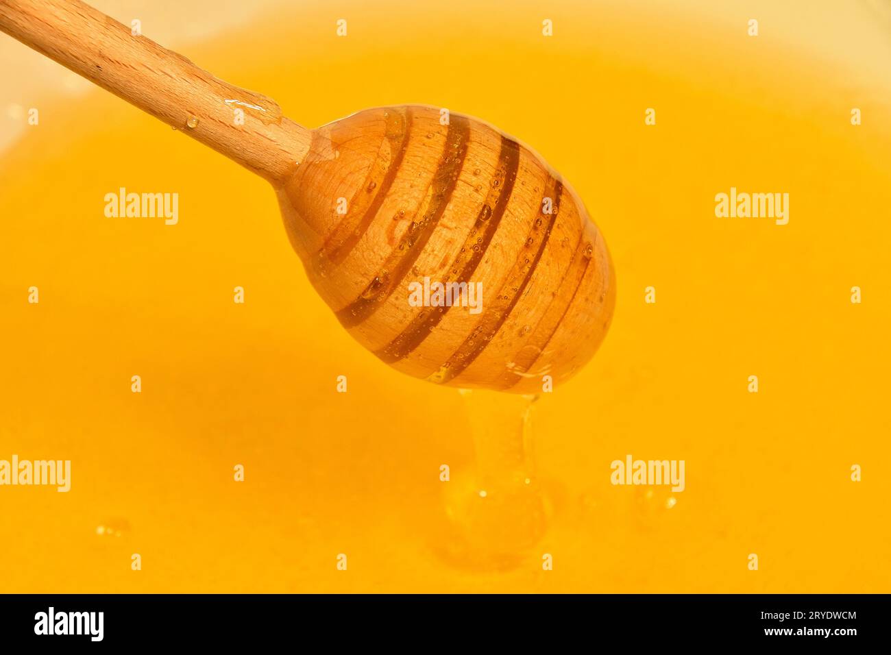Close up wooden dipper in honey bowl Stock Photo Alamy