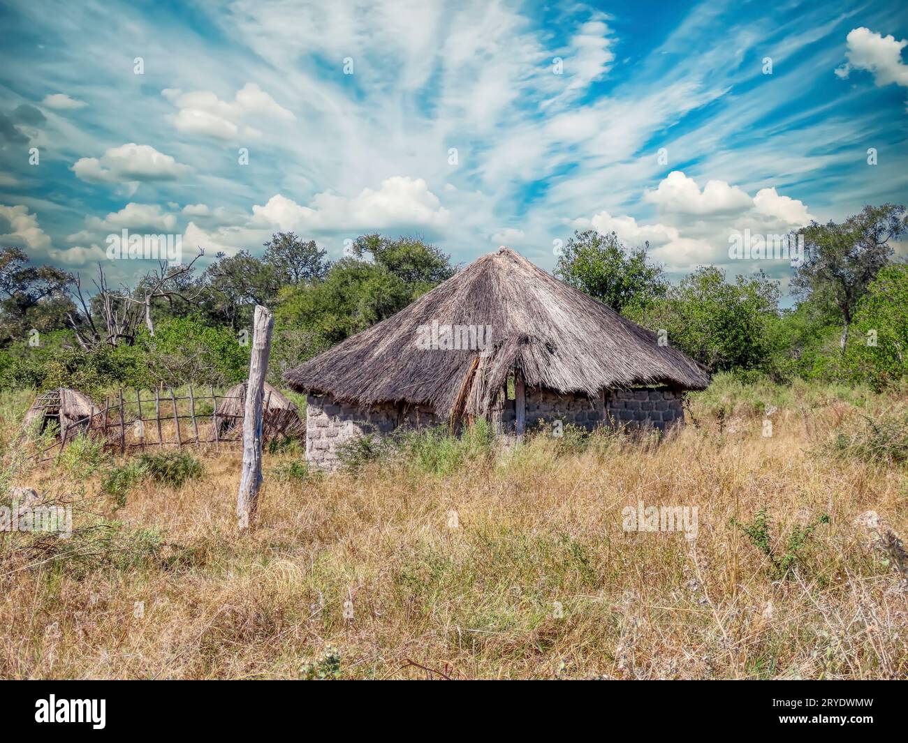 rondavel in the african bush in a ruined state, empty and dilapidated for a long time, daytime Stock Photo