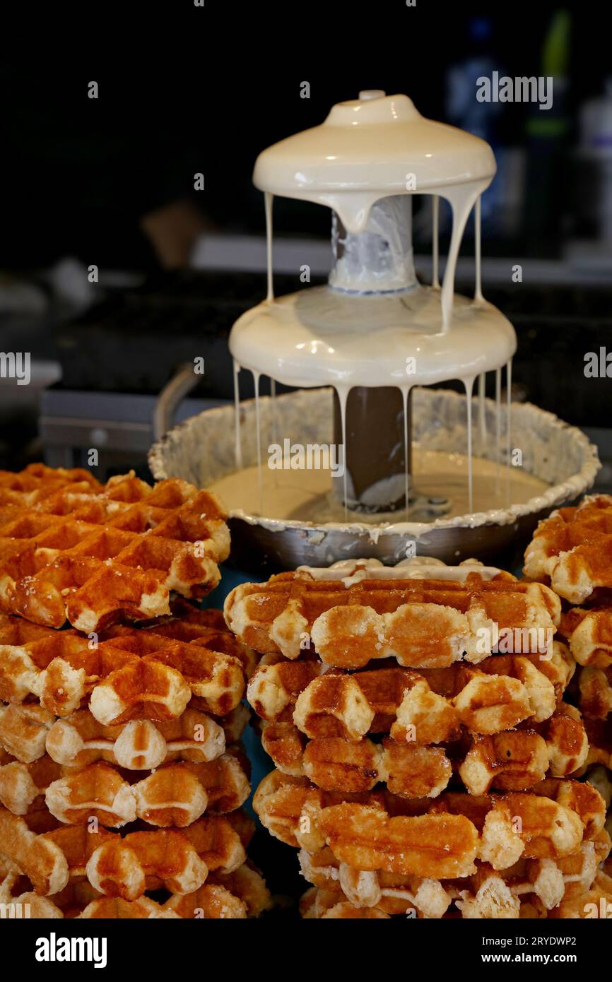 Close up Belgian wafers and white chocolate fountain Stock Photo Alamy