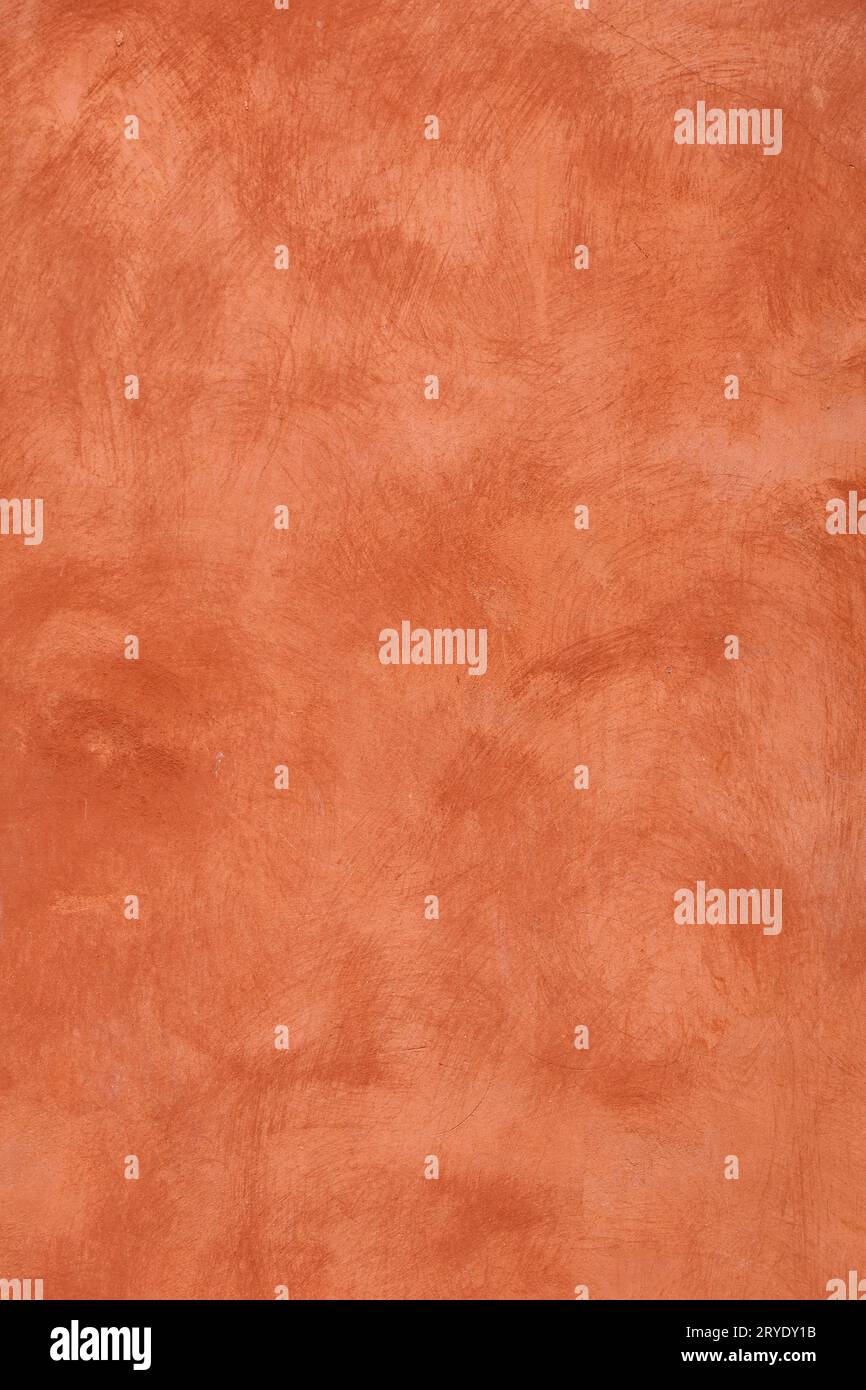 Grunge orange painted plaster wall background Stock Photo