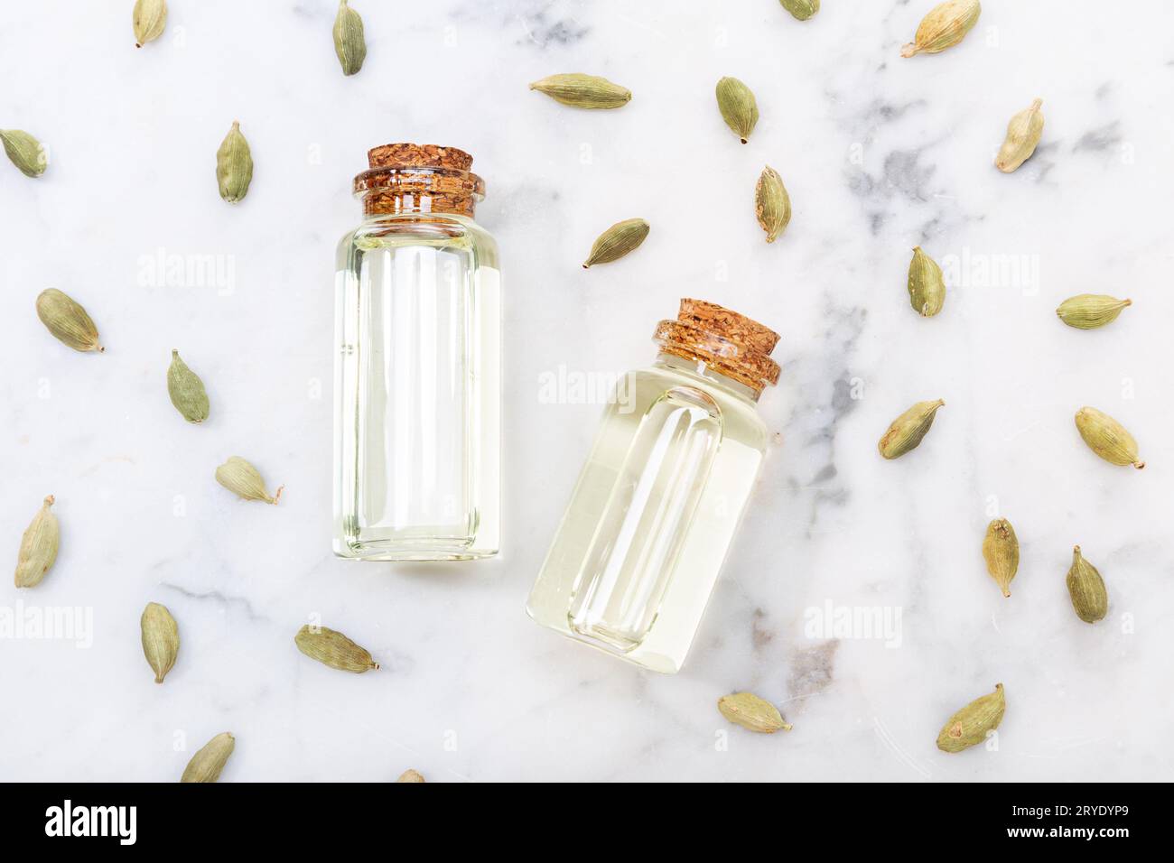Cardamom essential oil on marble table. Elettaria cardamomum Stock Photo