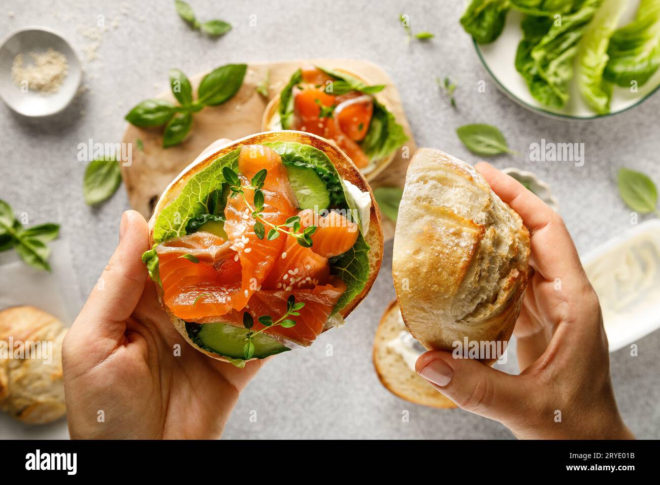 Salmon sandwiches with cream cheese, fresh romaine lettuce and cucumber, top down view Stock Photo