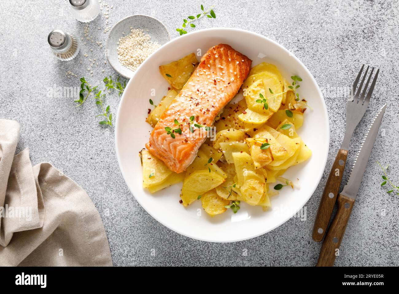 Salmon grilled and baked potato with onions, top down view Stock Photo