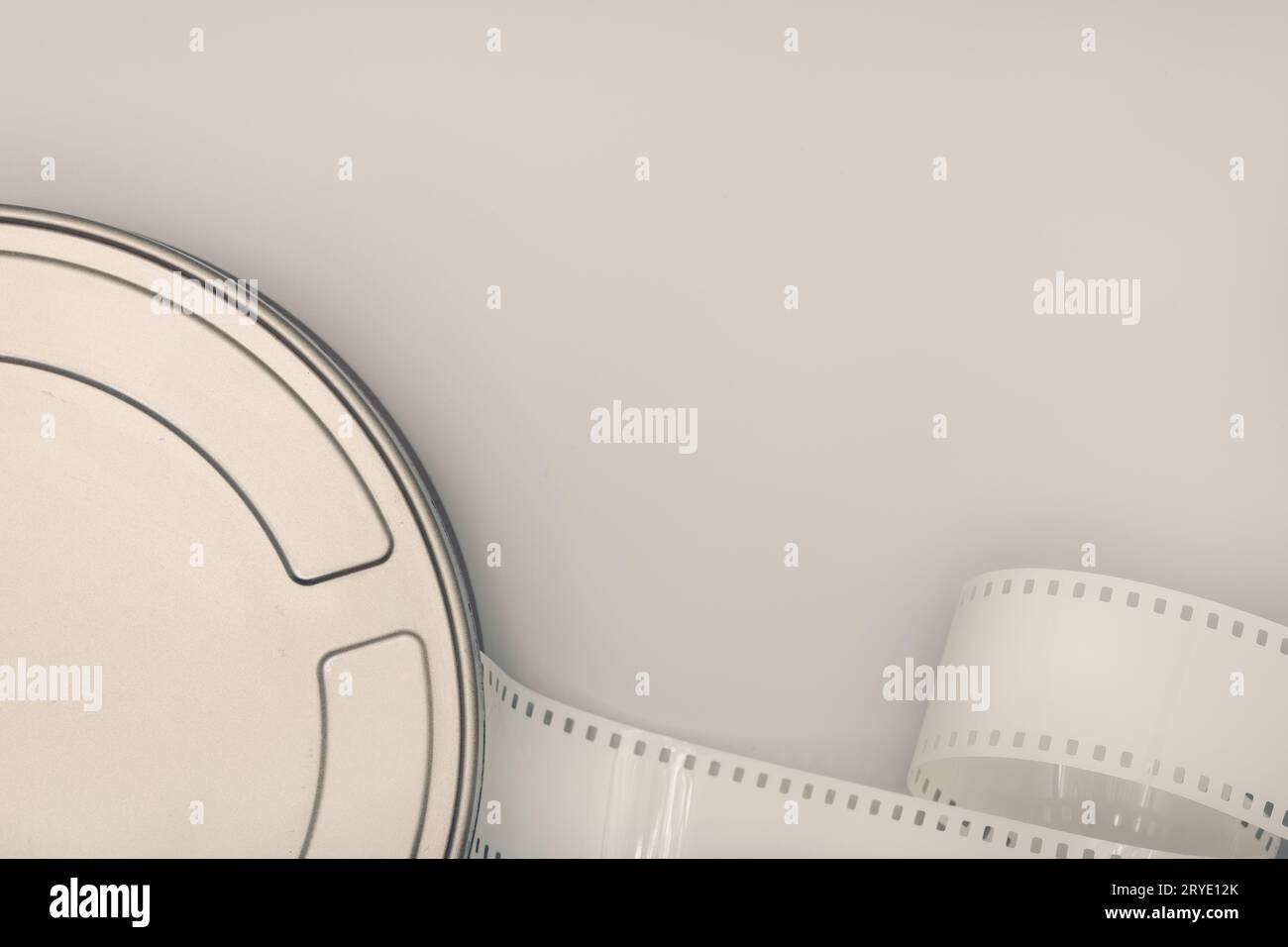 Motion Picture Film Can and film strip on table Stock Photo