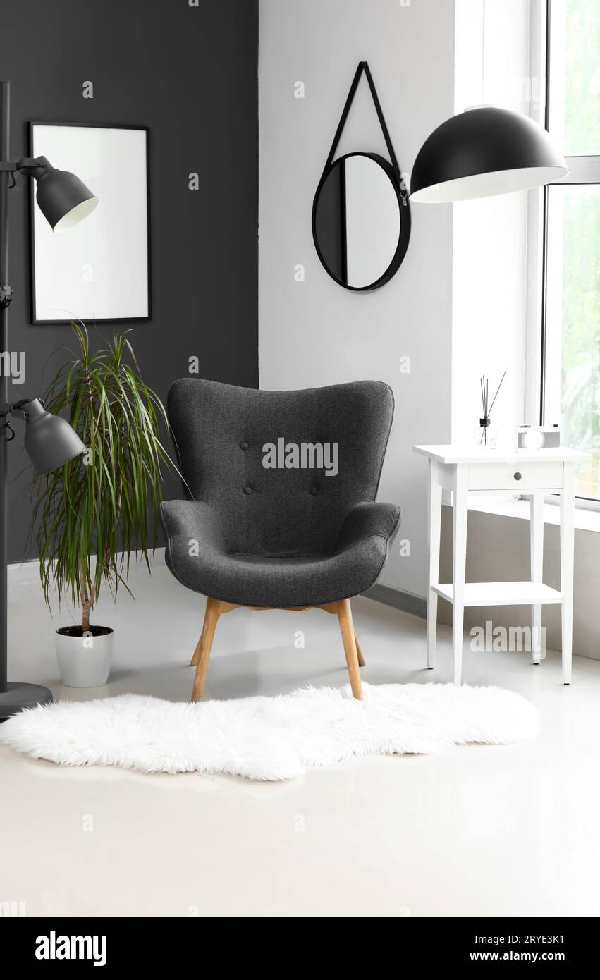 Interior of modern living room with black armchair and lamp Stock Photo ...