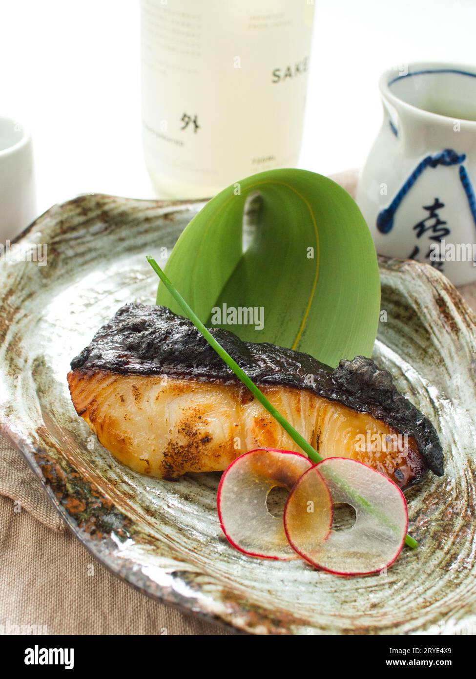 Black cod broiled on a plate with garnishes at a Japanese restaurant. Stock Photo