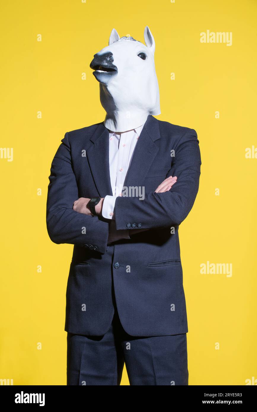 Man with horse mask on yellow background Stock Photo Alamy