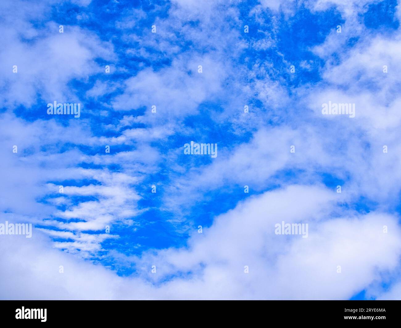 Unusual cloud formation, puffy clouds and striped clouds, in blue sky over Kona, Big Island, Hawaii. Stock Photo