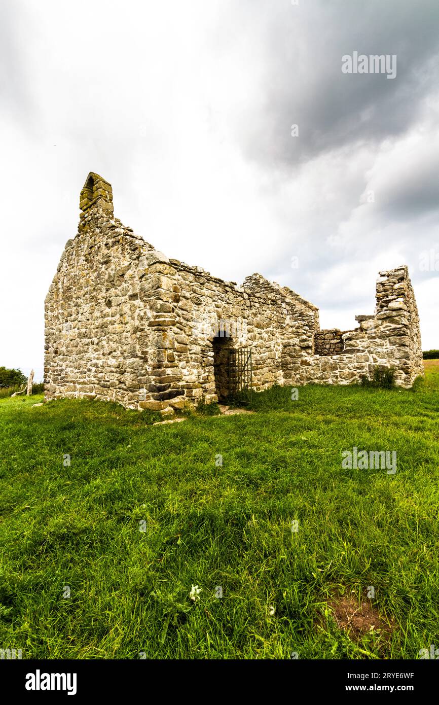 Capel lligwy, ruin of twelfth century chapel or church, sky as copyspace, top. Near Moelfre, Anglesey, North Wales, UK, portrait, wide angle Stock Photo
