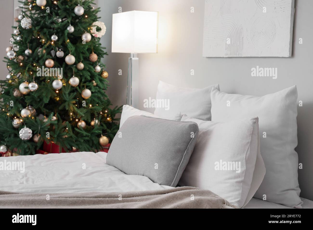 Cozy bed with Christmas pillows decorated with Christmas decor Stock Photo  - Alamy