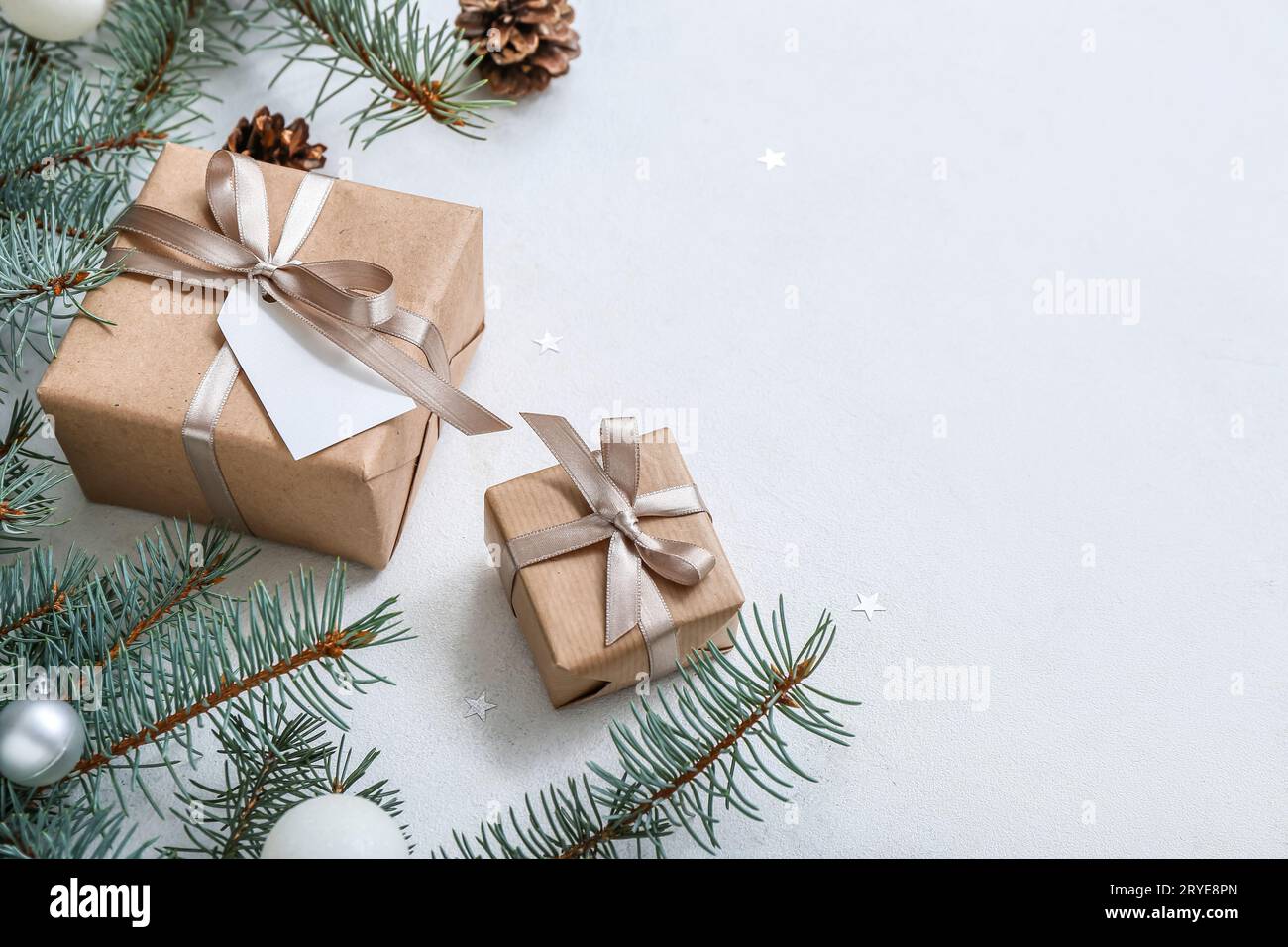 Christmas tree branches and gift boxes on white background Stock Photo ...