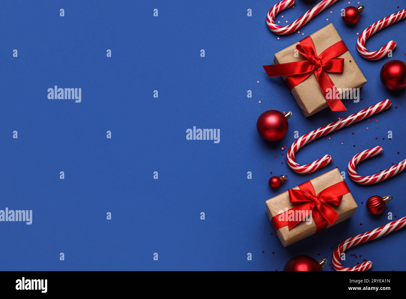 Christmas composition with candy canes, red balls and gift boxes on ...