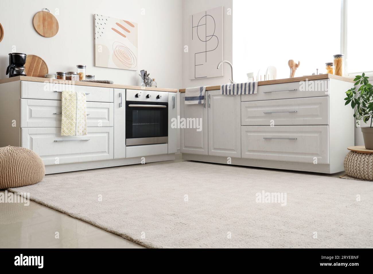 Interior of light kitchen with white counters and soft carpet Stock ...