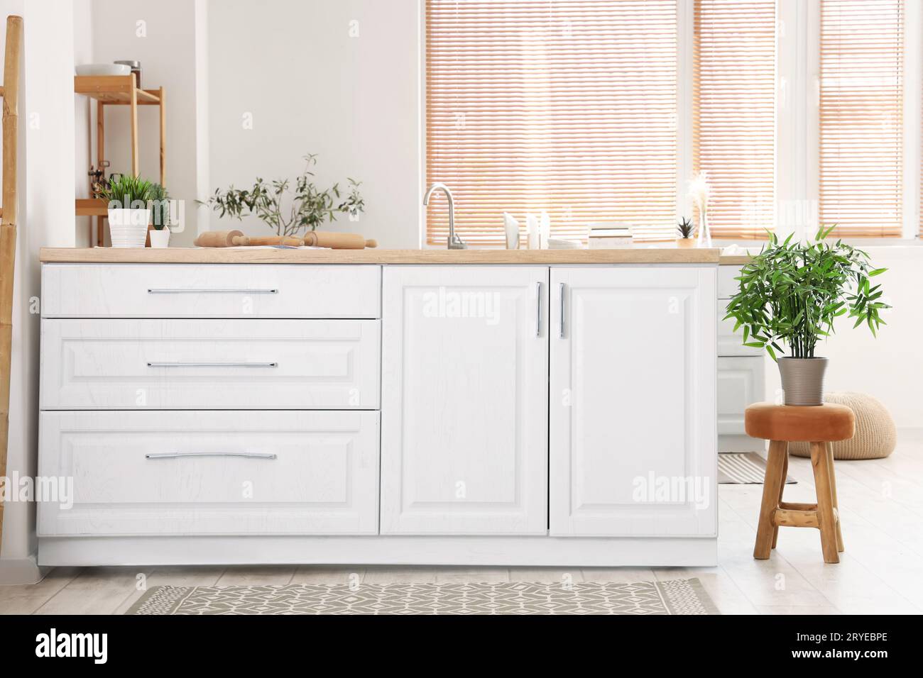Interior of light kitchen with white counters and carpets Stock Photo ...