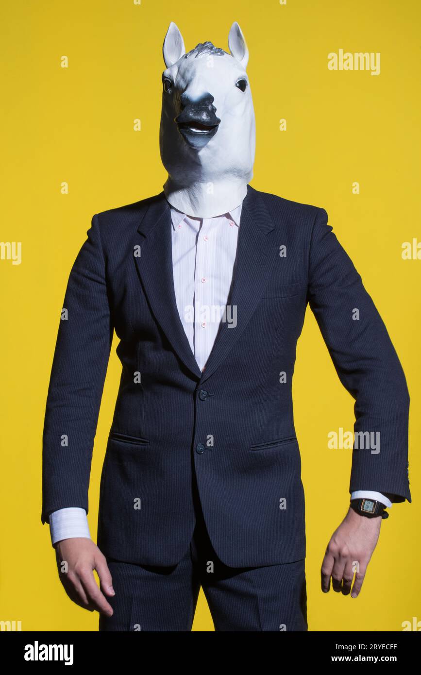Man with horse mask on yellow background Stock Photo Alamy