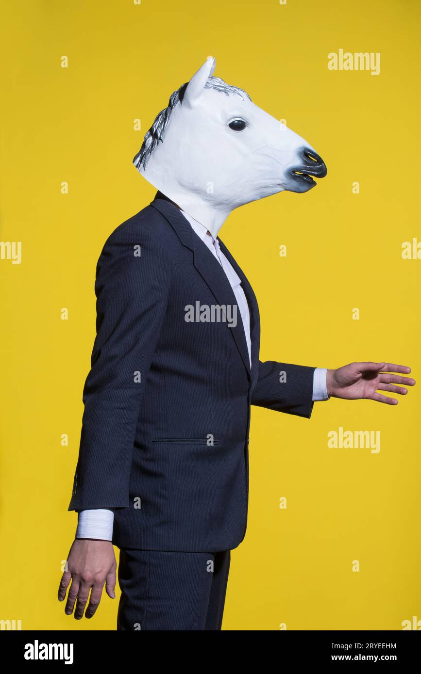 Man with horse mask on yellow background Stock Photo Alamy