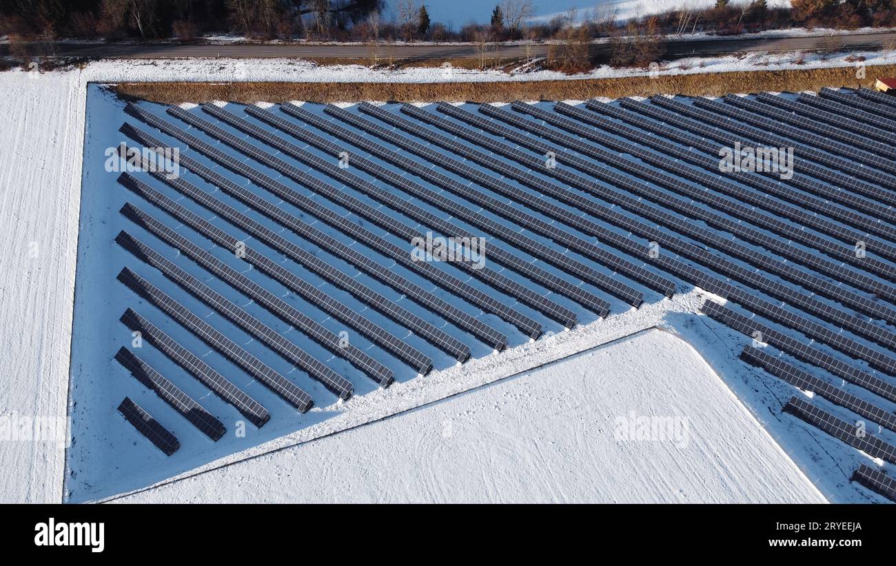 Aerial view with drone of large solar farm in meadow in winter Stock Photo
