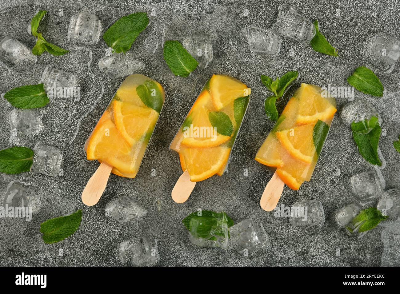 Orange and mint ice cream popsicles on table Stock Photo