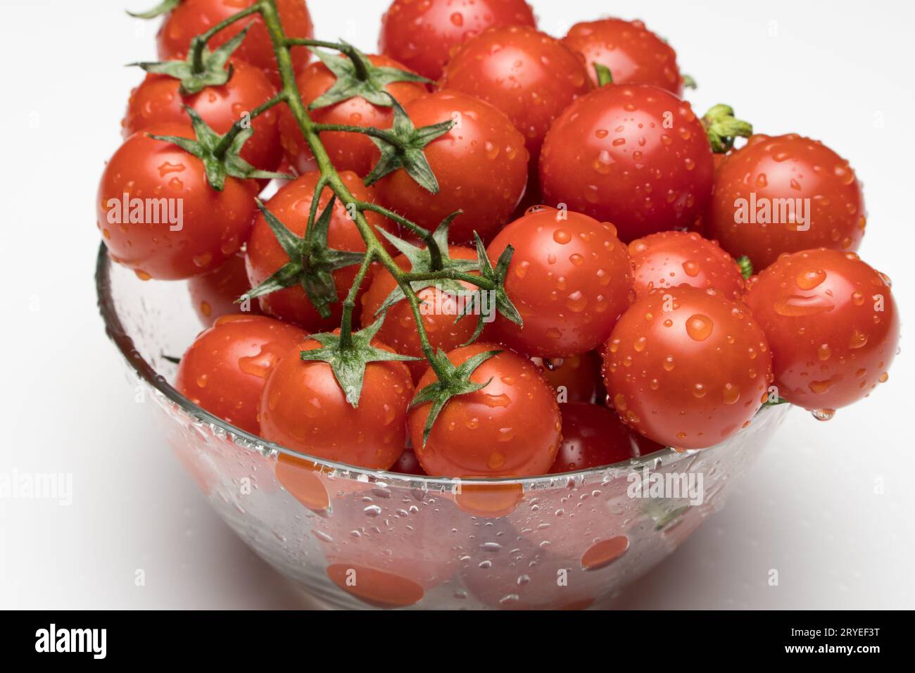 Tomatoes in a glass bowl Stock Photo