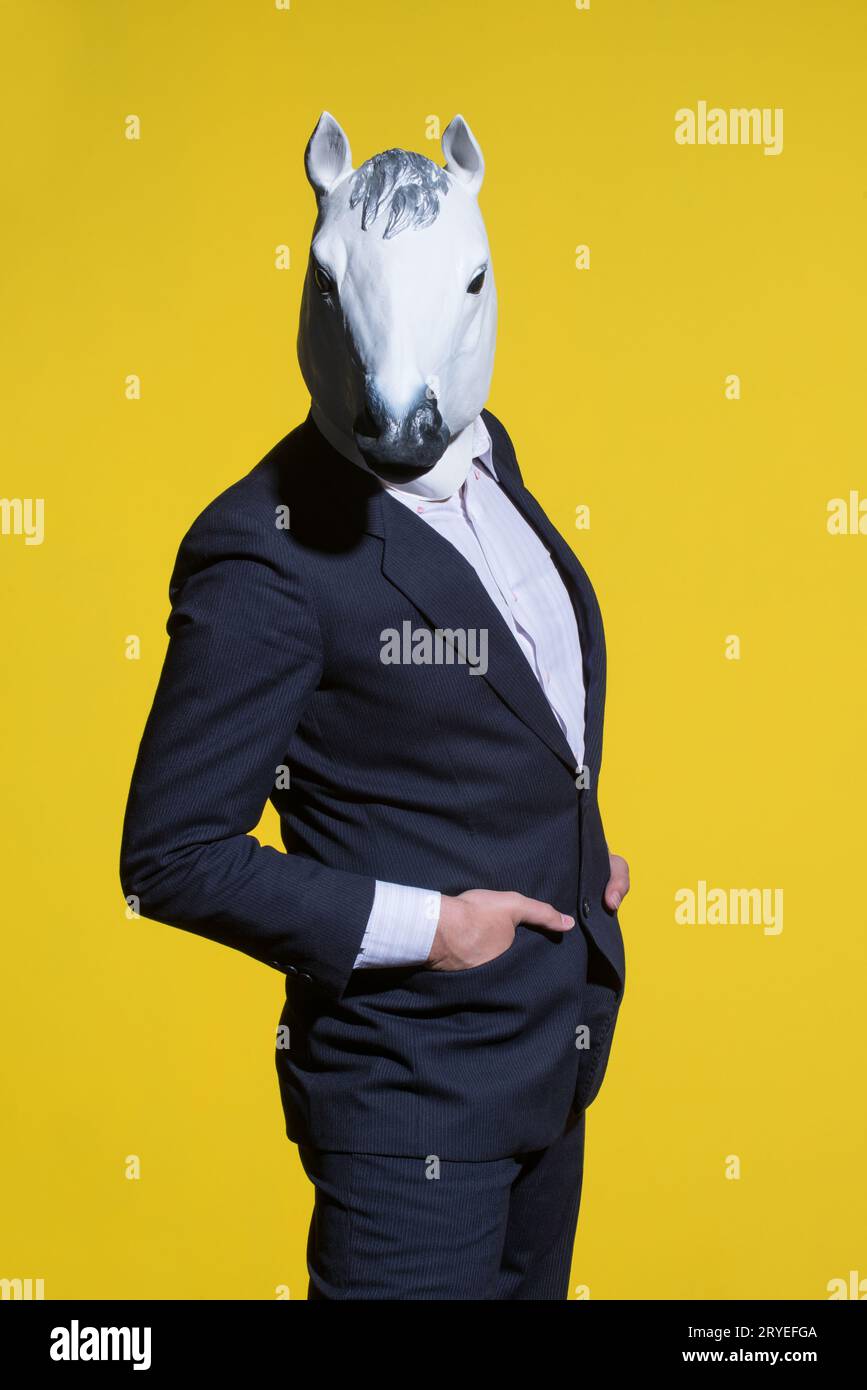 Man with horse mask on yellow background Stock Photo Alamy