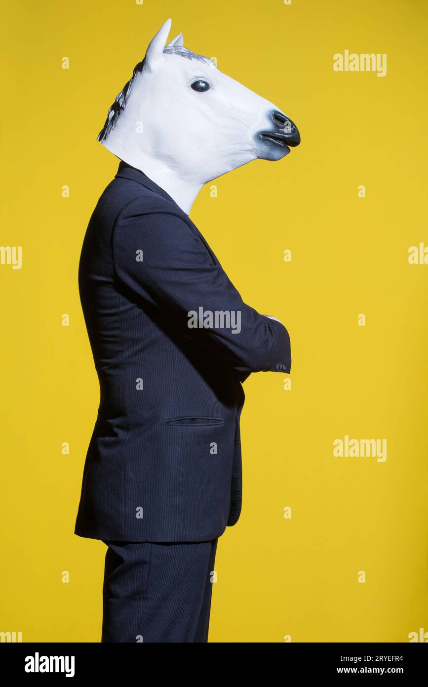 Man with horse mask on yellow background Stock Photo Alamy