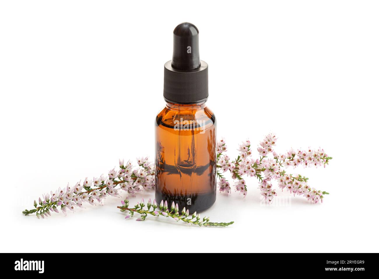 Heather essential oil on amber bottle isolated on white background Stock Photo