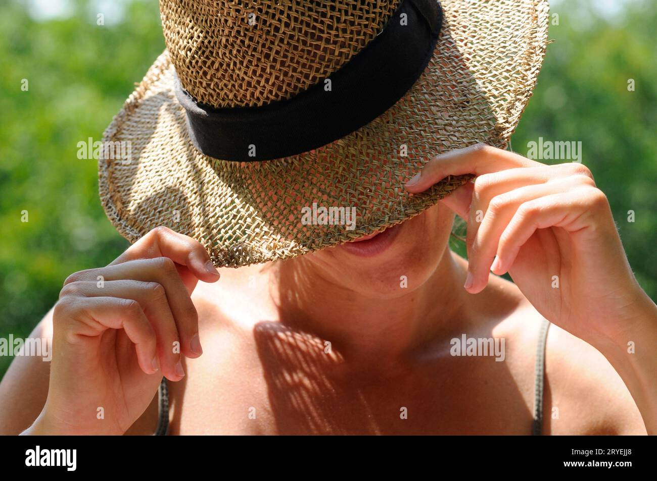 Wearing hat for sun protection Stock Photo