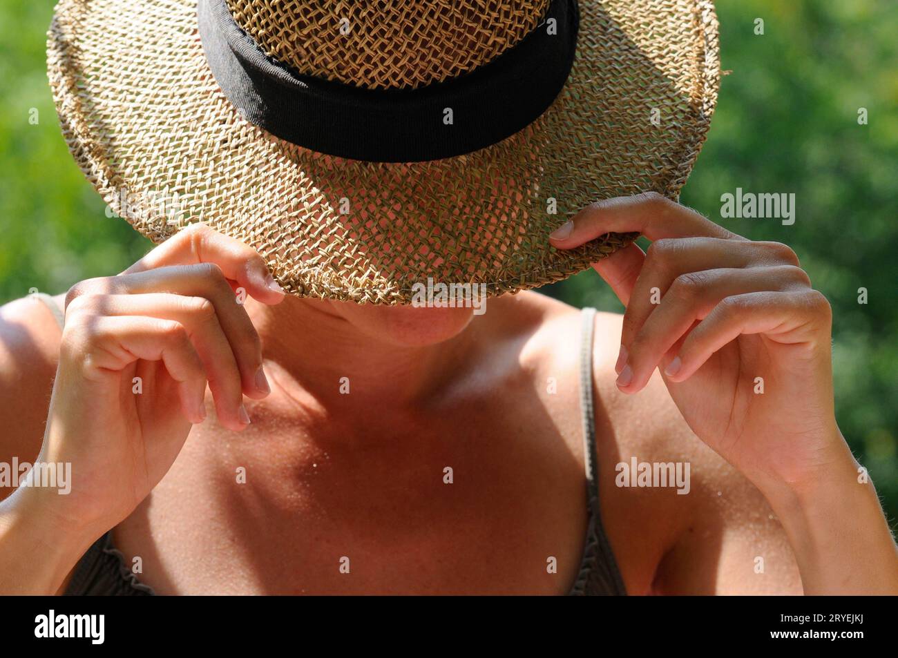 Wearing hat for sun protection Stock Photo