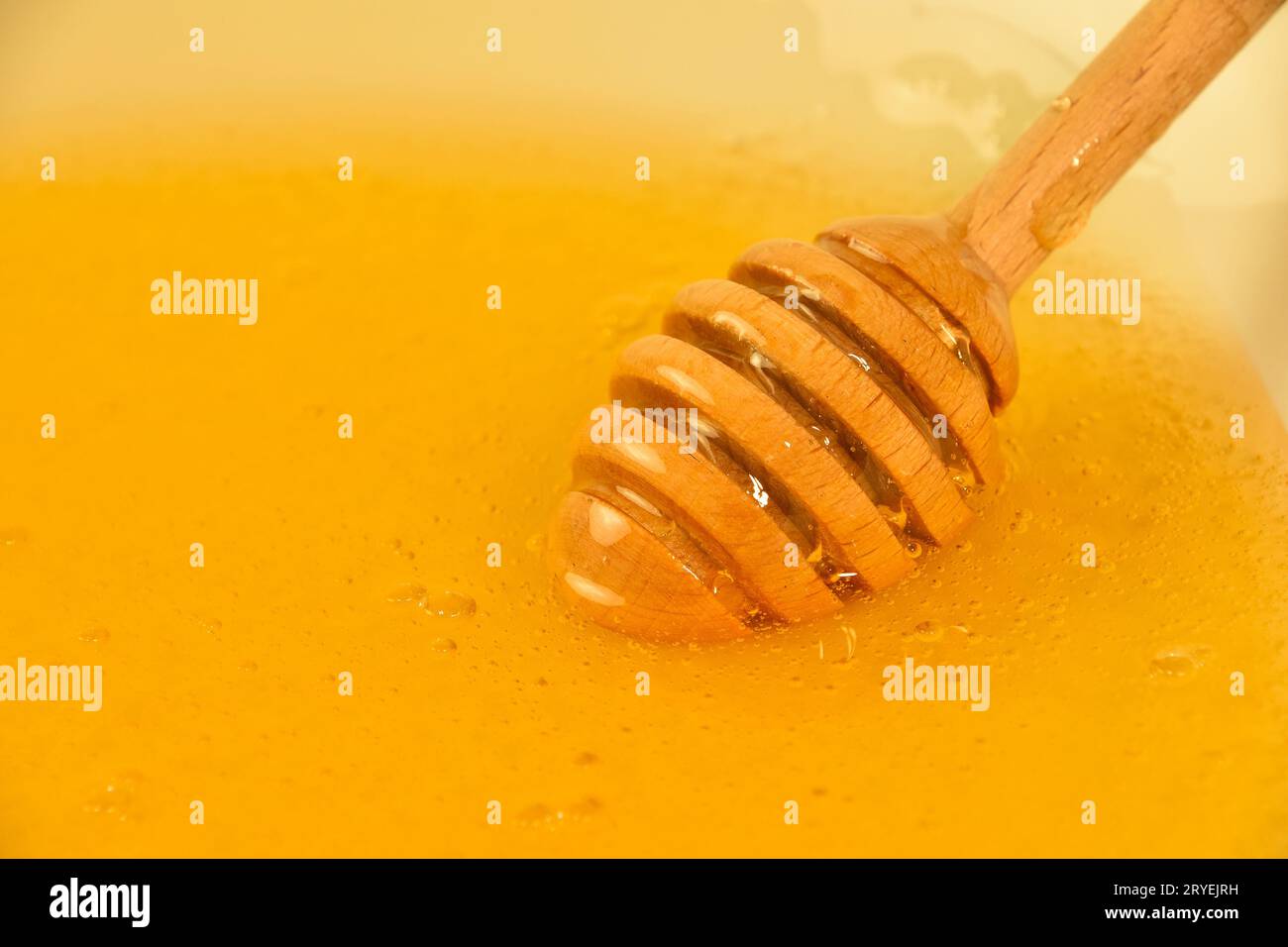 Close up wooden dipper in honey bowl Stock Photo Alamy