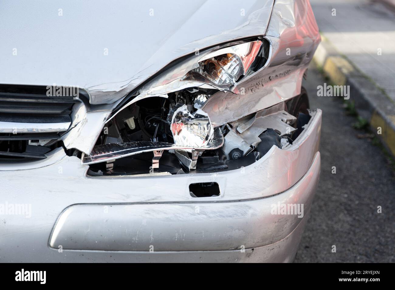 Car crash or accident. Front fender and light damage and scratches on bumper Stock Photo