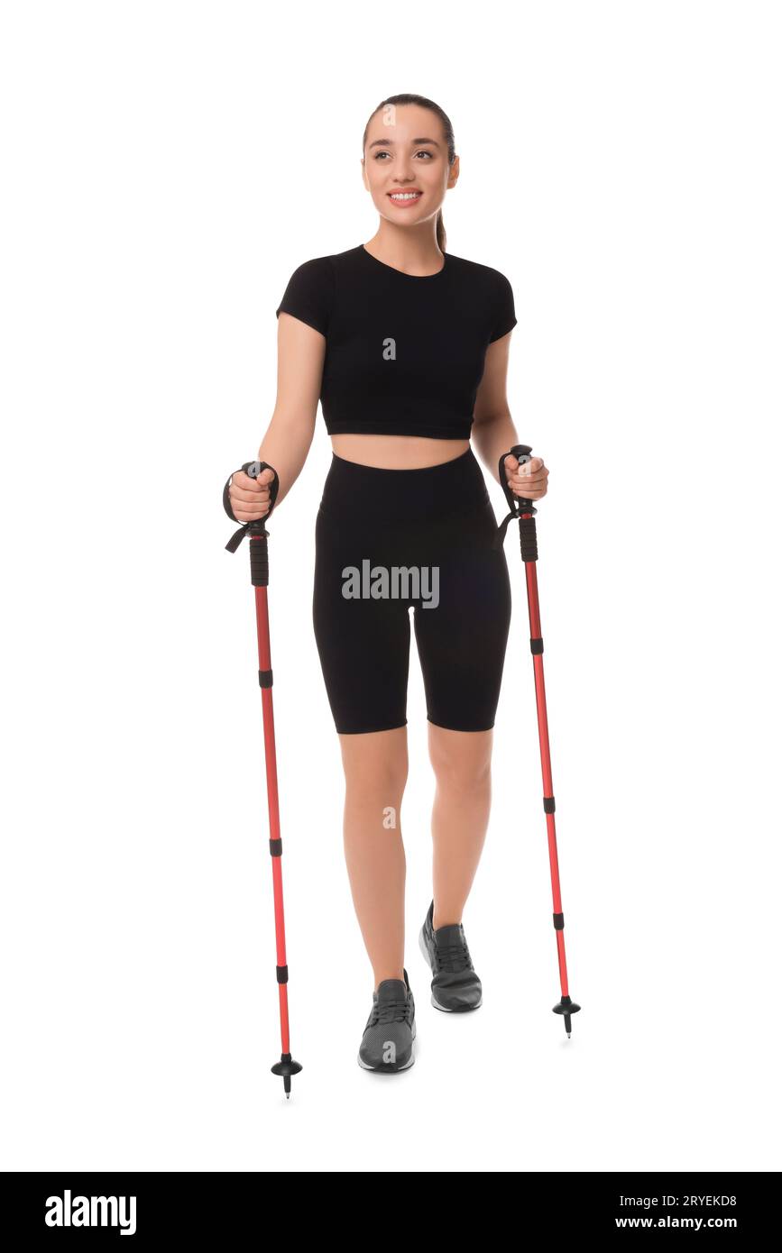 Young woman practicing Nordic walking with poles isolated on white Stock Photo