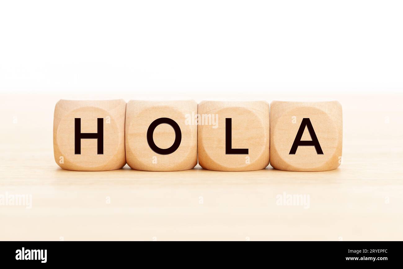 Hello word in spanish language in wooden blocks on table. White
