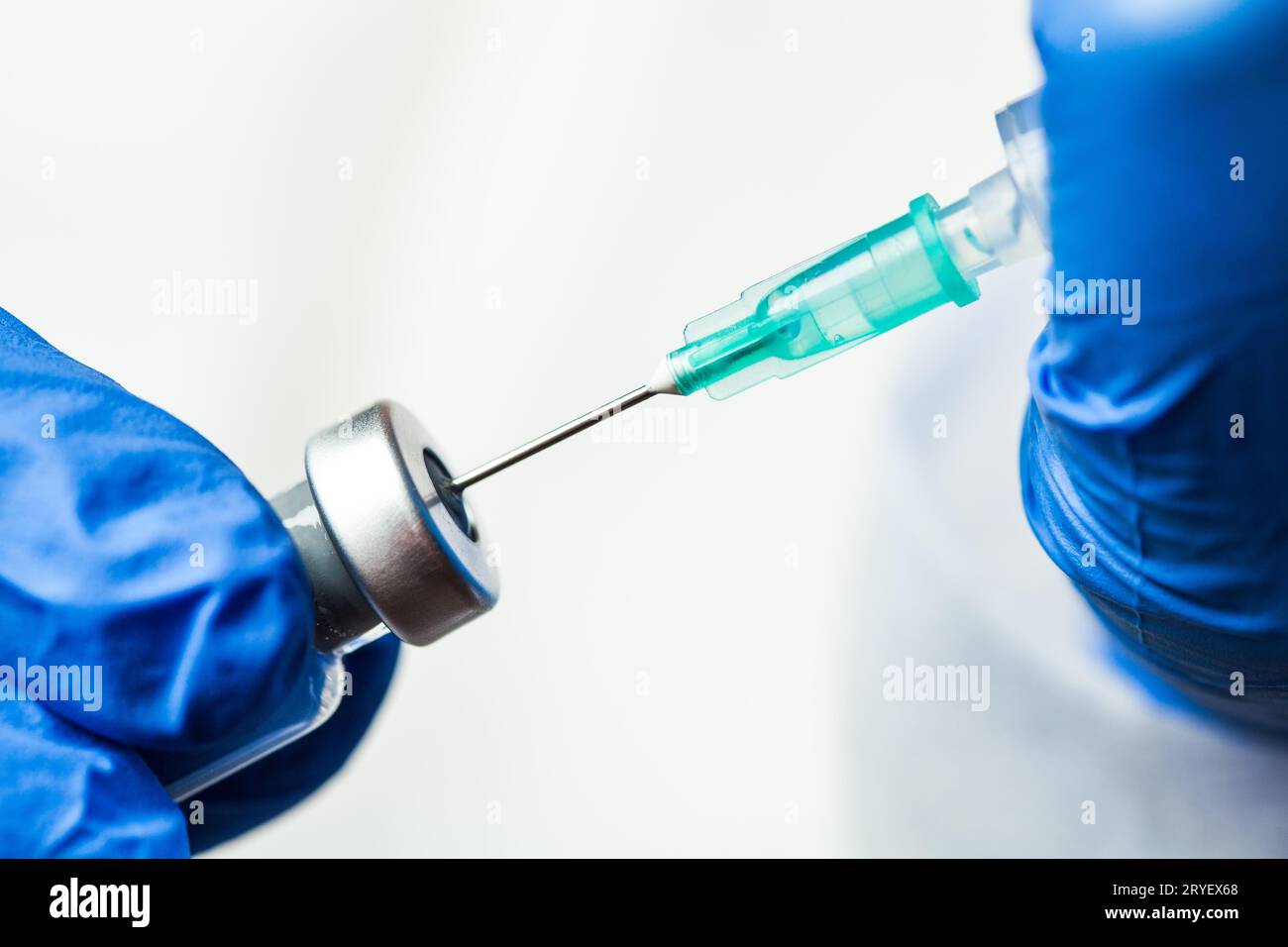 Detail closeup of syringe needle in ampoule vial,UK nurse taking injection shot Stock Photo