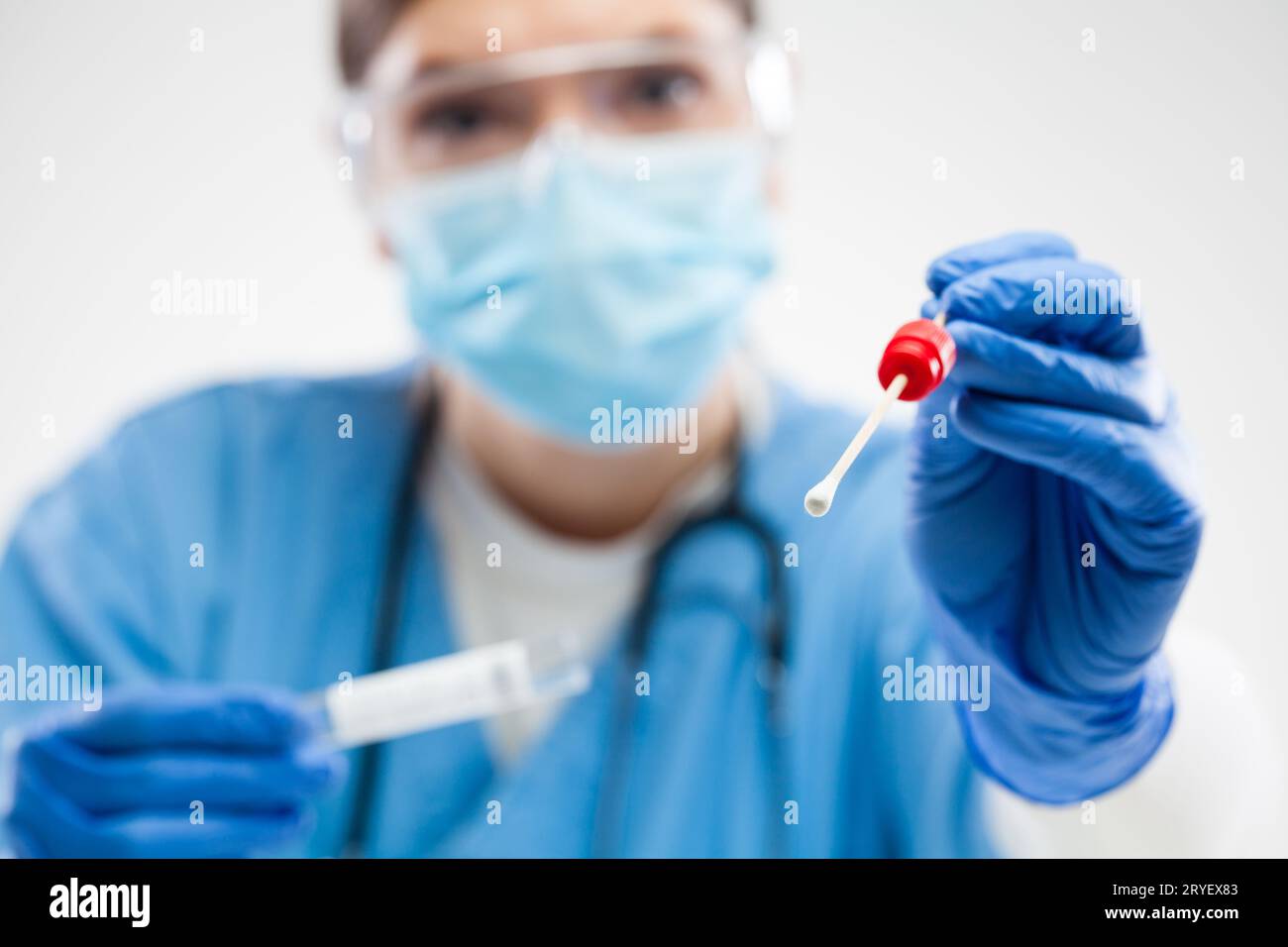 Female medical frontline worker holding throat or nose swabbing stick Stock Photo