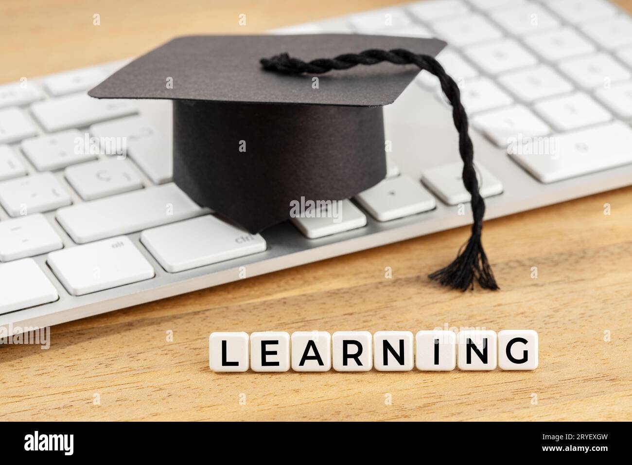 Learning concept. Graduation cap on computer keyboard Stock Photo Alamy