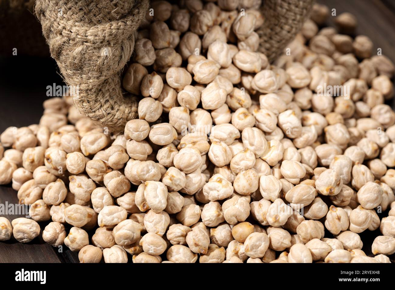 Close up of Uncooked Chickpeas on rustic wooden table Stock Photo