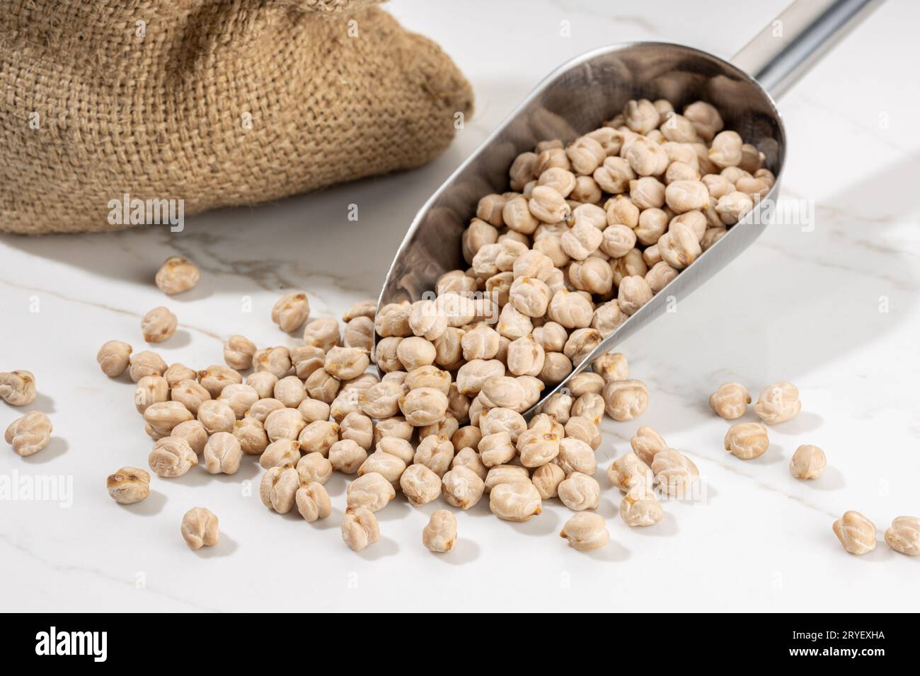 Chickpea on scoop on White marble Background. Cicer arietinum Stock Photo