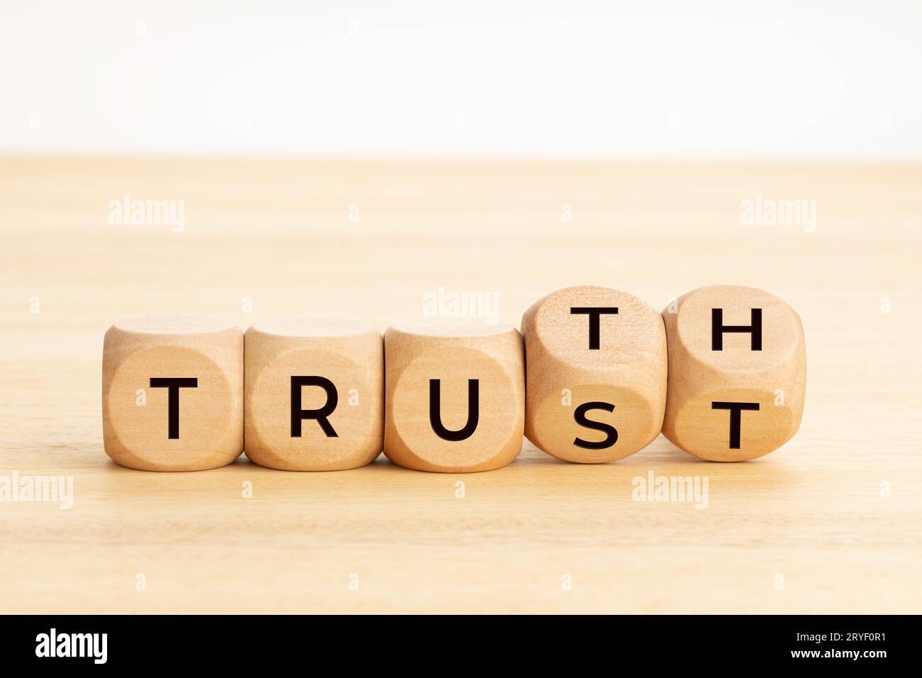 Truth or trust concept. Text on wooden blocks. White background. Copy space Stock Photo