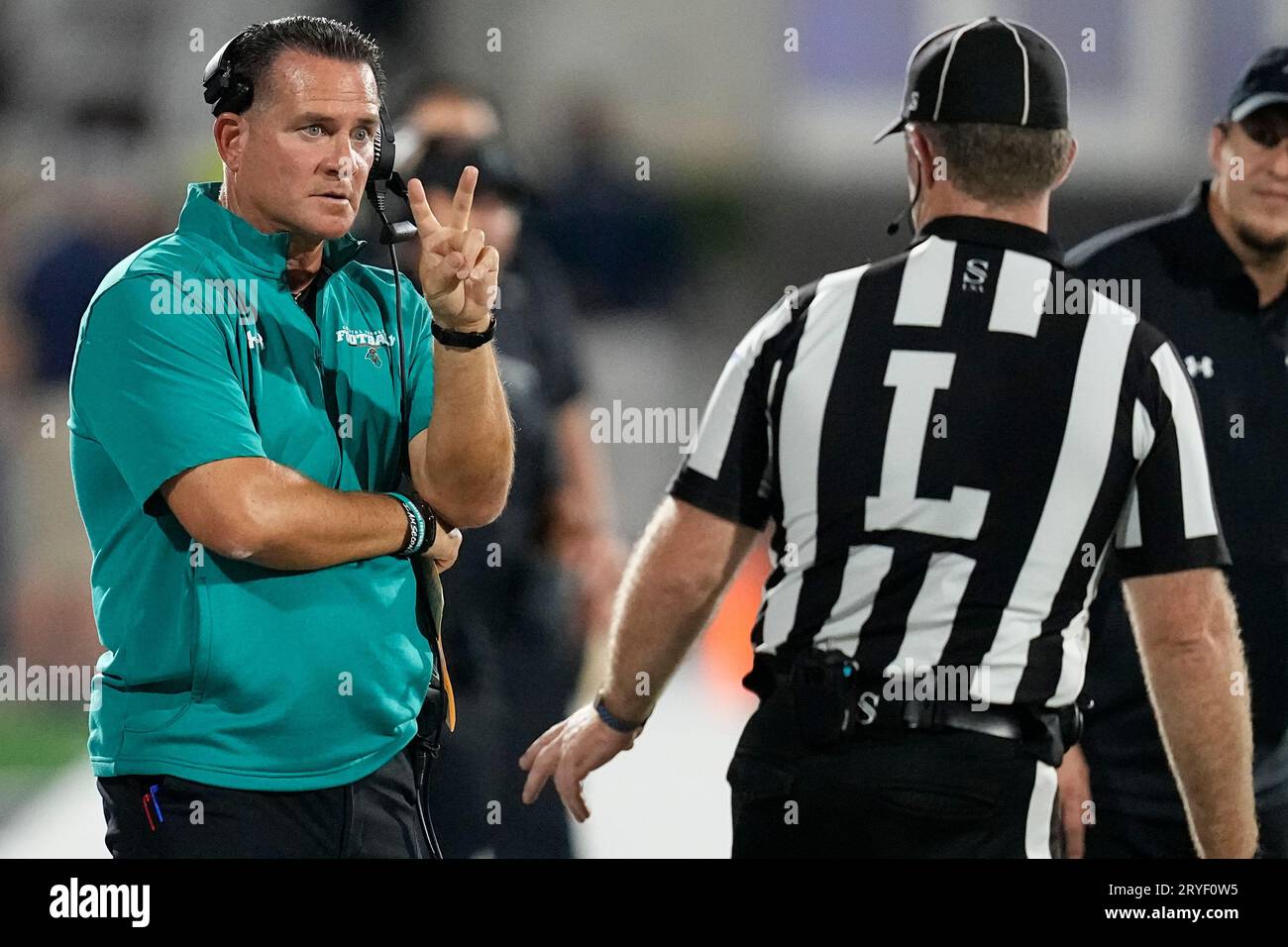 Coastal Carolina head coach Tim Beck speaks to an official during the