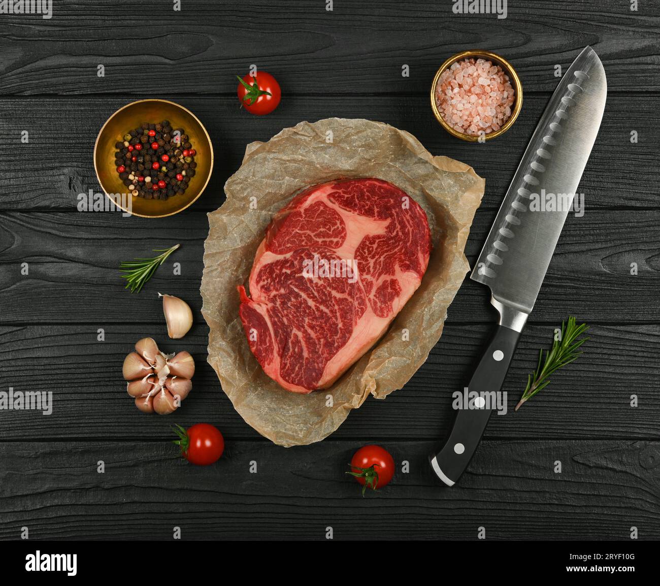 Close up raw beef ribeye steak on paper Stock Photo