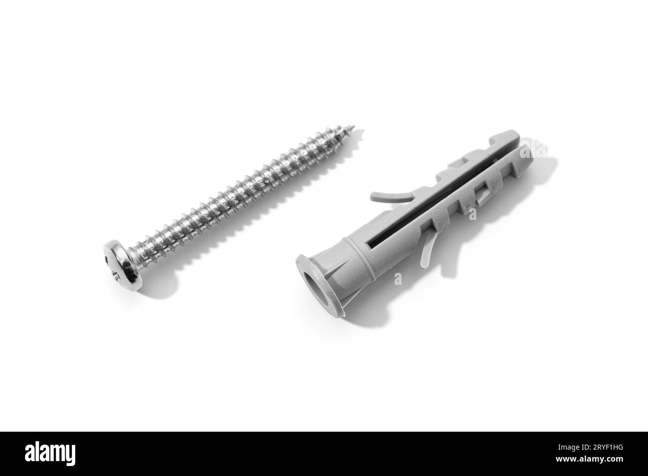 Plastic dowel and screw isolated on a white background. Expansion anchors or fixing dowel with chromed screw Stock Photo