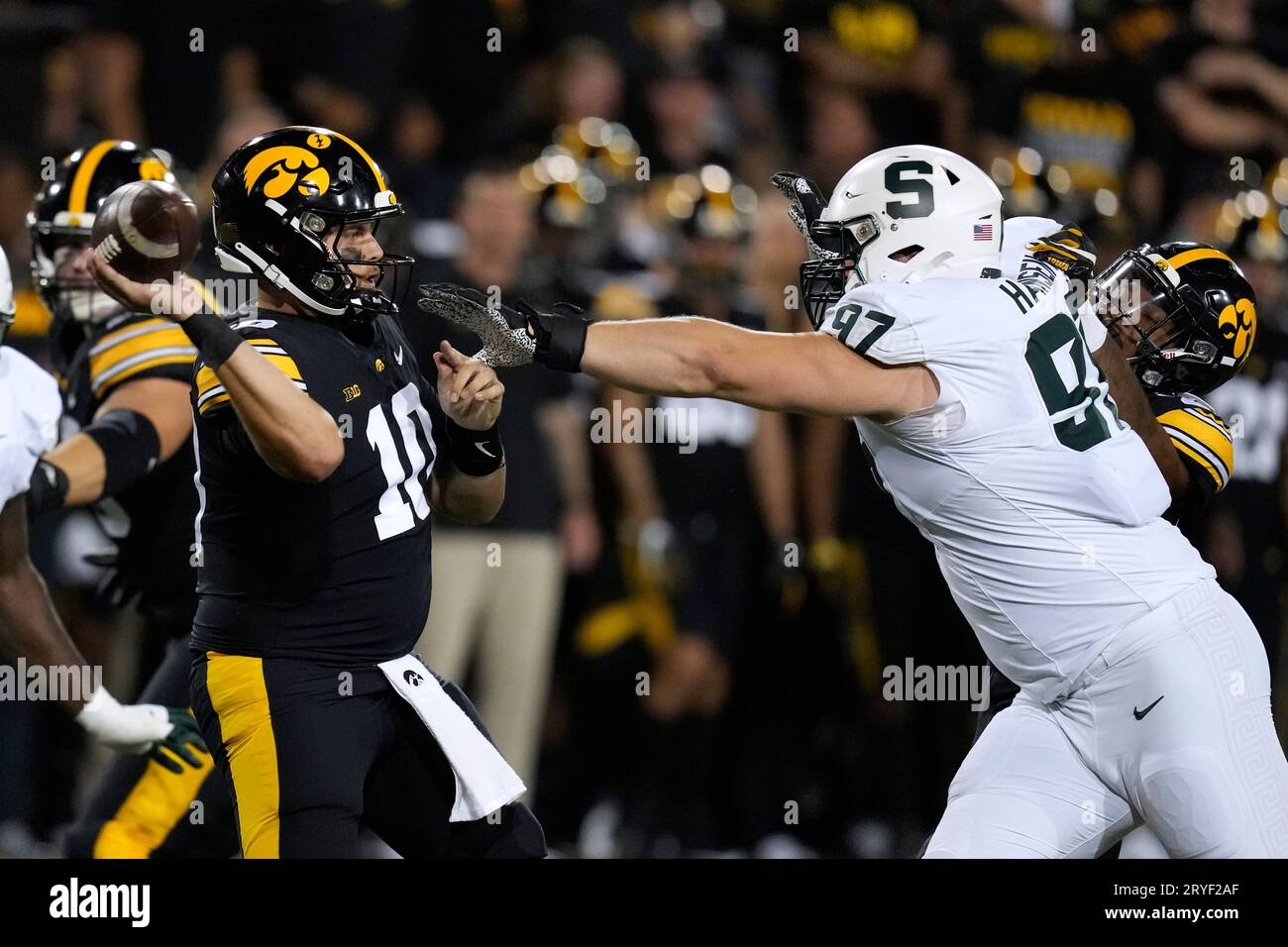 Iowa quarterback Deacon Hill (10) throws a pass as he is pressured by ...