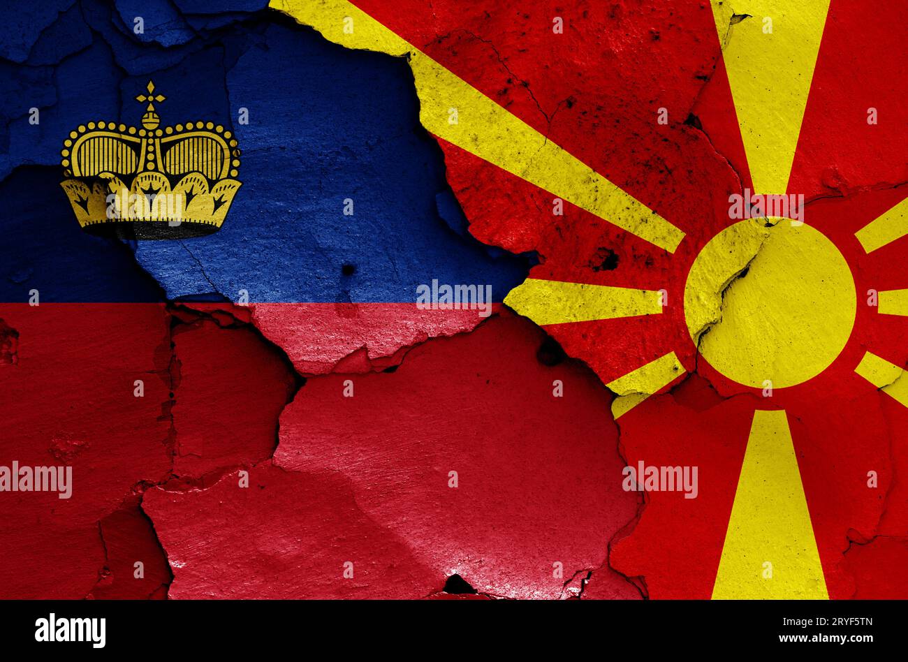 Flags of Liechtenstein and North Macedonia painted on cracked wall ...