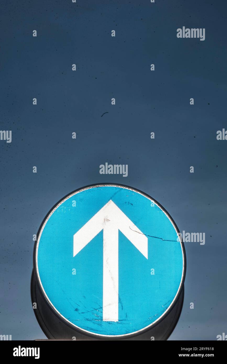 Direction arrow points in one way Stock Photo