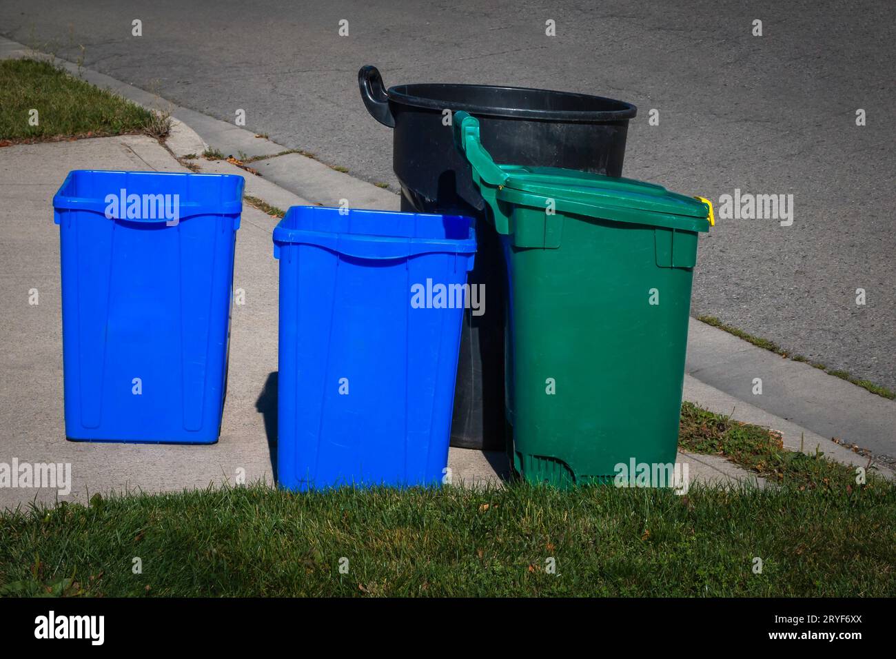 Close up of recycle and garbage bins on roadside for pick up, waste