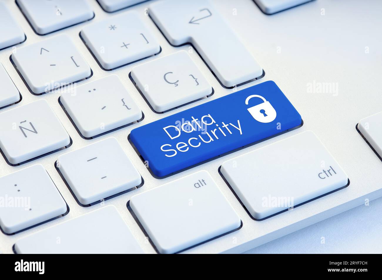 Cyber Security word and padlock icon on blue computer keyboard Stock Photo