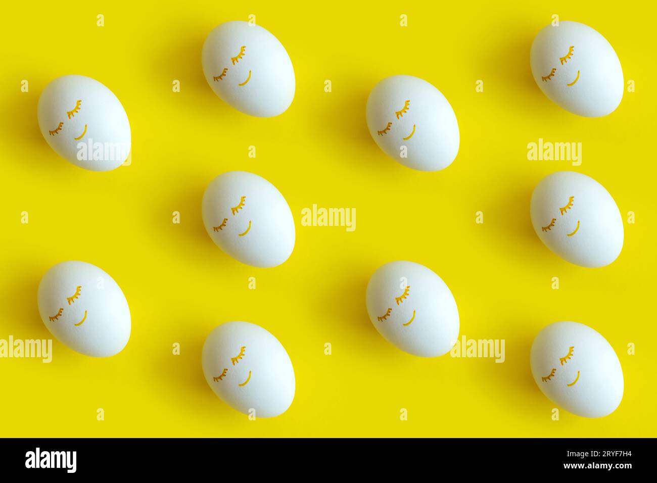Easter eggs pattern on colorful yellow background. Top view, flatlay. Stock Photo