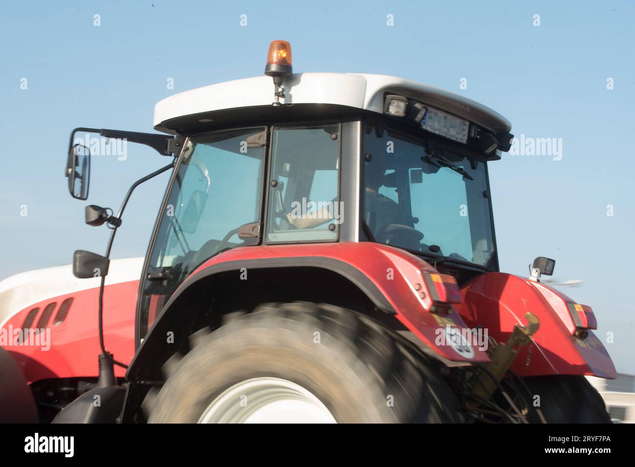 Farmer with tractor on the field Stock Photo - Alamy