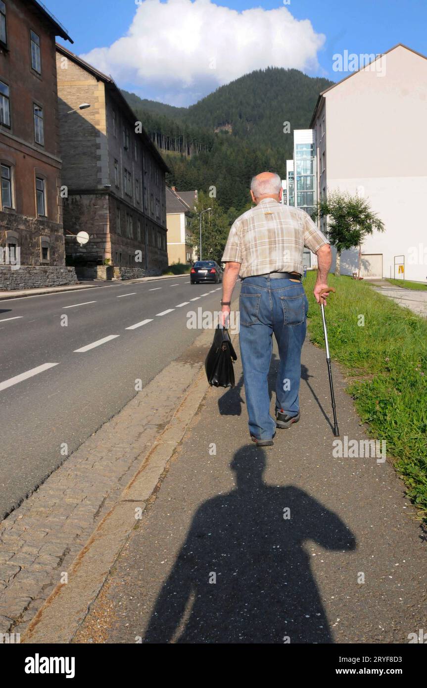 Senior man with a walking stick Stock Photo - Alamy